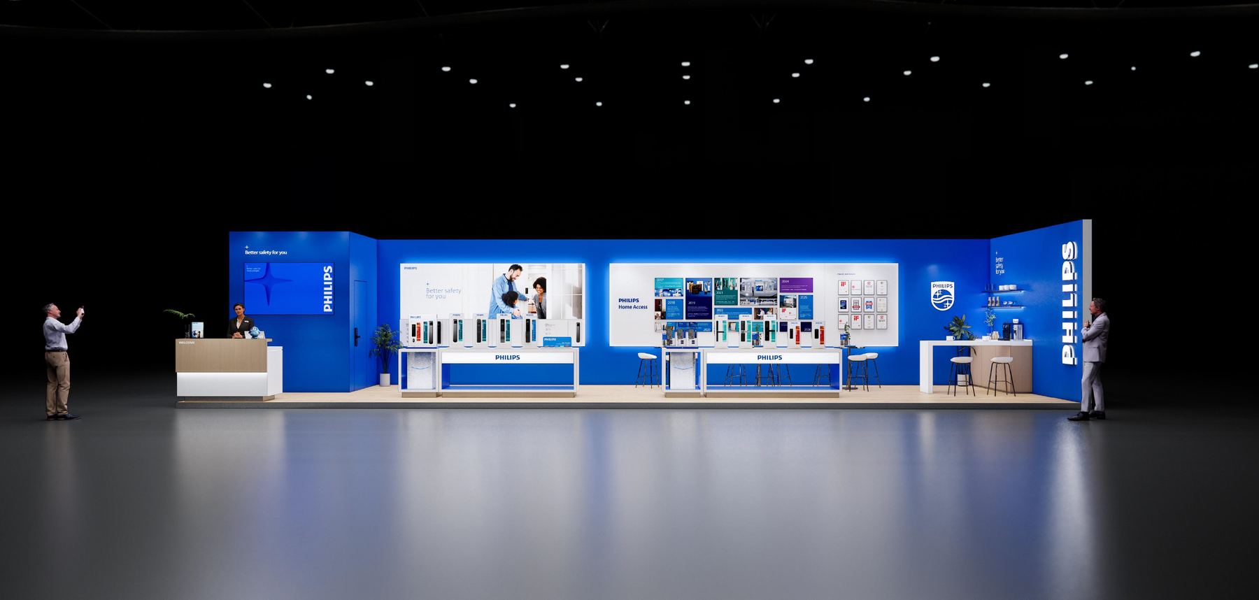 The Philips stand seen head-on in a darkened exhibition hall, a long blue wall lit from within